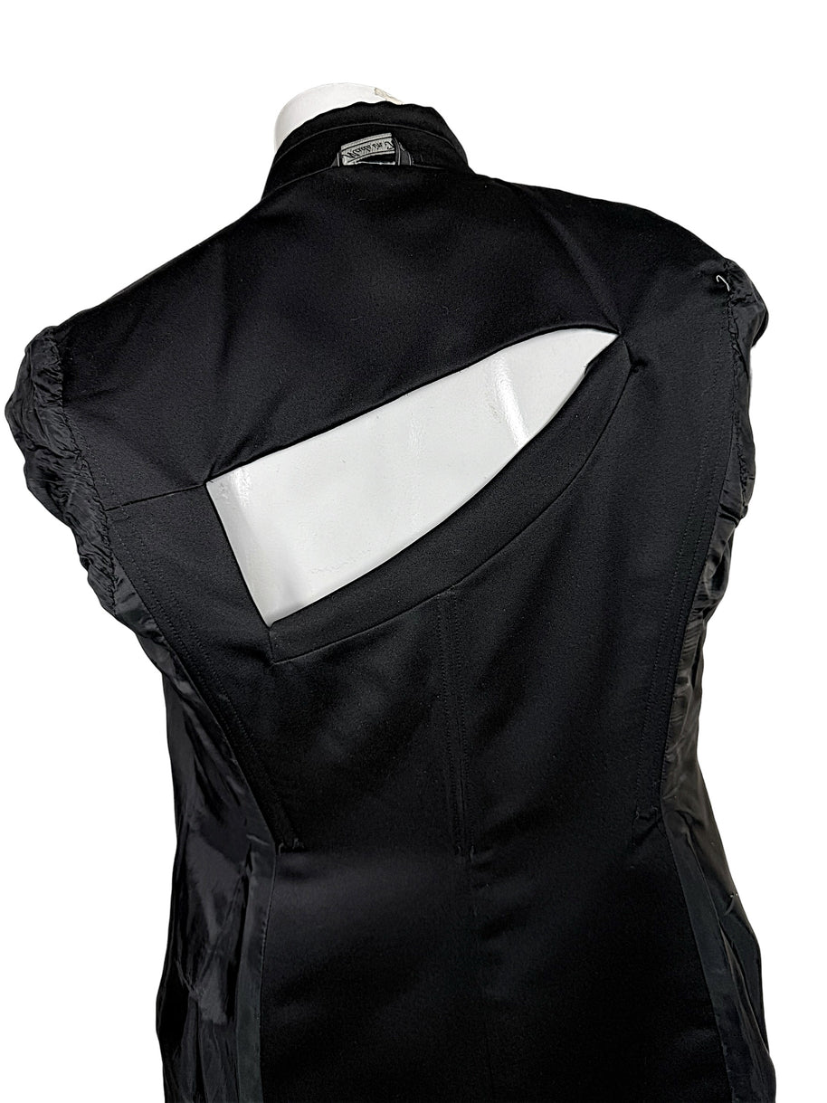 Interior back view of vintage Gianni Versace Couture black tailored blazer showing the geometric cutout opening, overlapping fabric construction, black lining and structured seams.