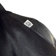 Close-up of the Italian size 42 tag inside a vintage Gianni Versace Couture black blazer, showing the label against black fabric and lining.