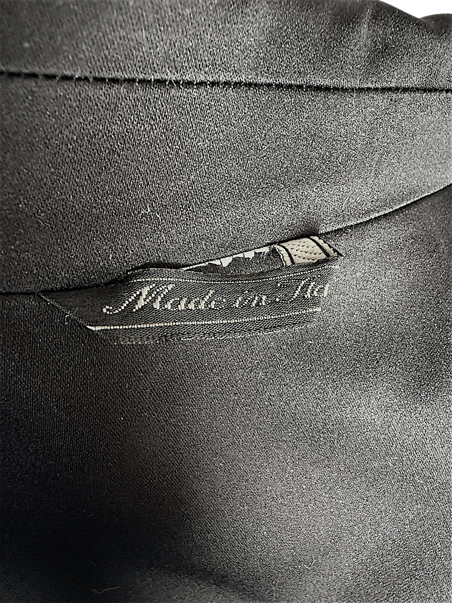 Close-up of the interior Made in Italy label and black lining inside a vintage Gianni Versace Couture tailored blazer.