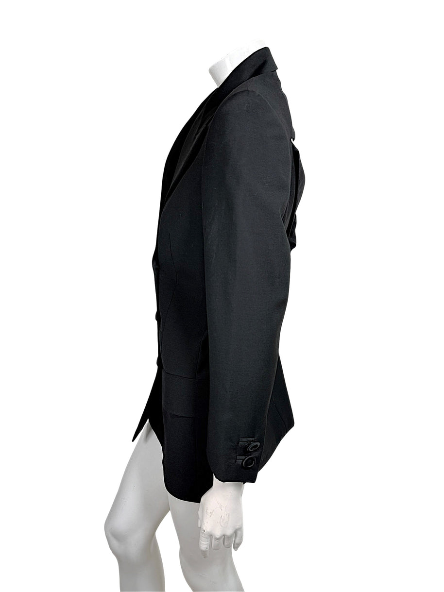 Side view of vintage Gianni Versace Couture black longline blazer showing tailored waist shaping, structured shoulder and decorative sleeve buttons.