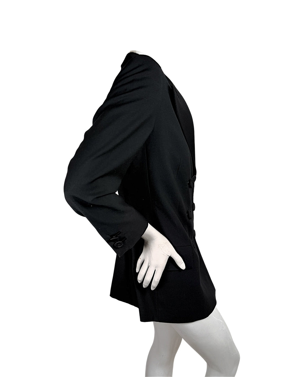 Side profile of vintage Gianni Versace Couture black tailored blazer highlighting the structured shoulder, fitted waist, long sleeve and elongated hem.
