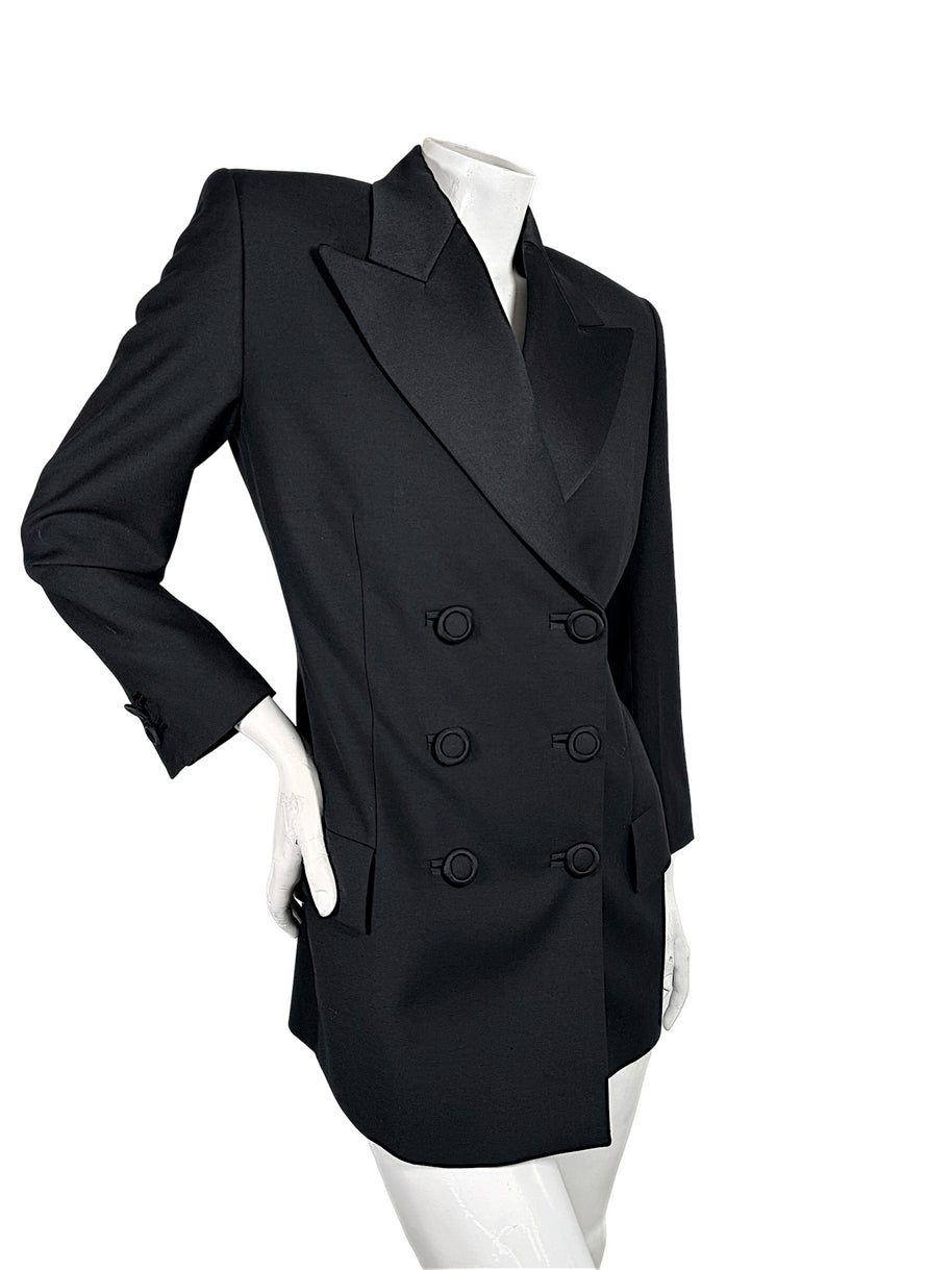 Three-quarter front view of vintage Gianni Versace Couture black longline blazer showing dramatic peaked lapels, defined waist and double-breasted buttons.
