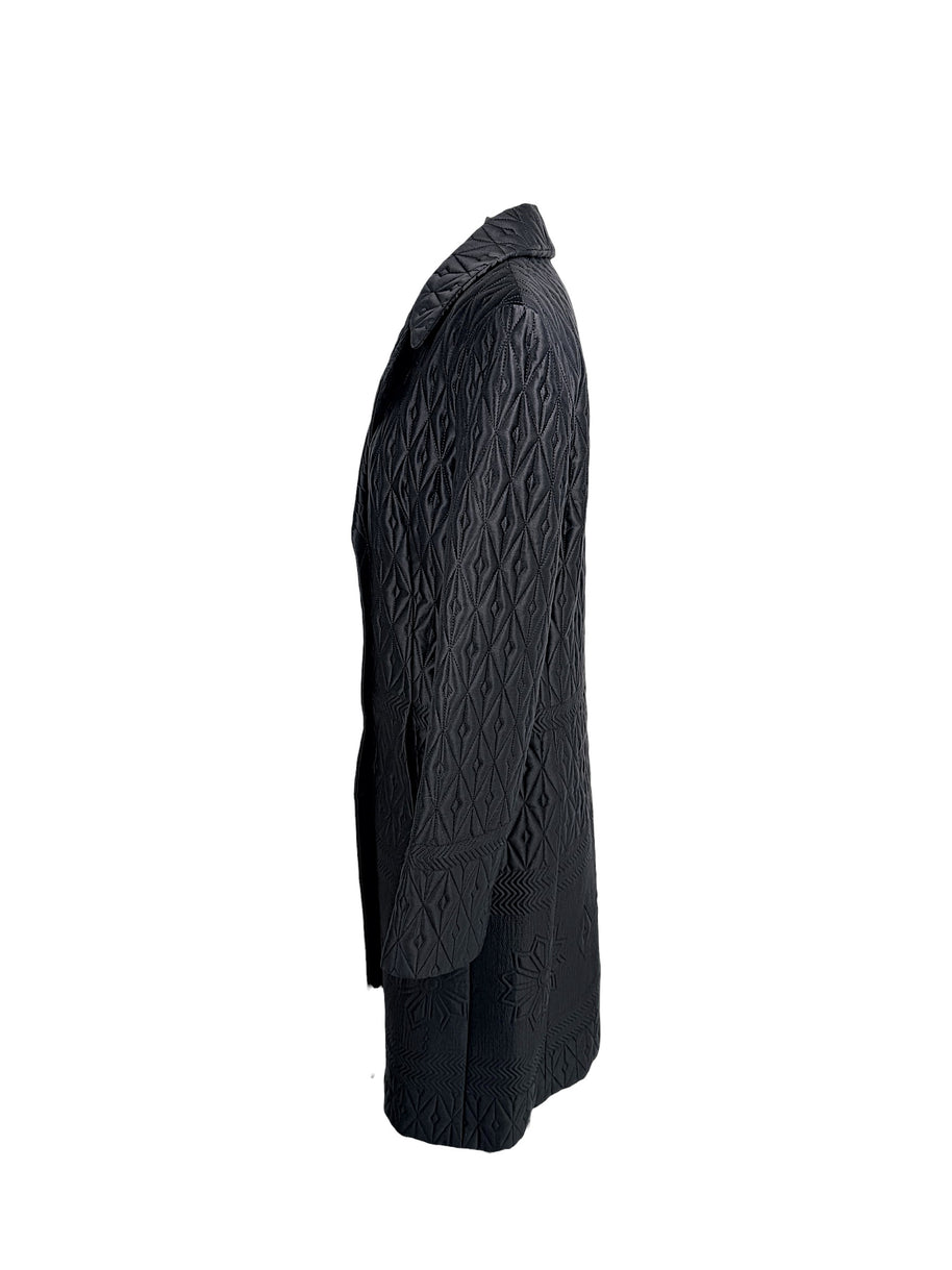 Side profile of vintage Guy Laroche Paris Collection black quilted longline jacket with structured silhouette.