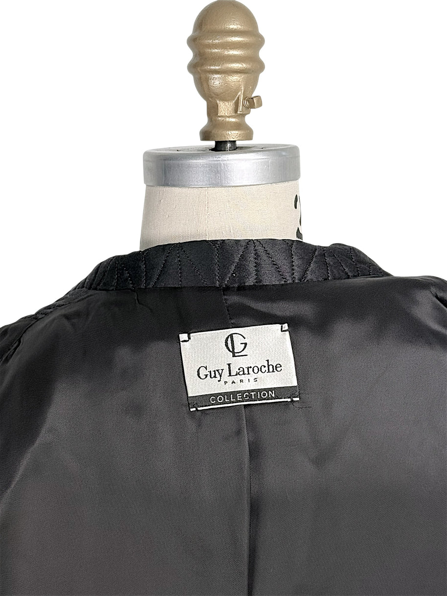 Close-up of vintage Guy Laroche Paris Collection designer label inside black quilted jacket.