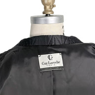 Close-up of vintage Guy Laroche Paris Collection designer label inside black quilted jacket.