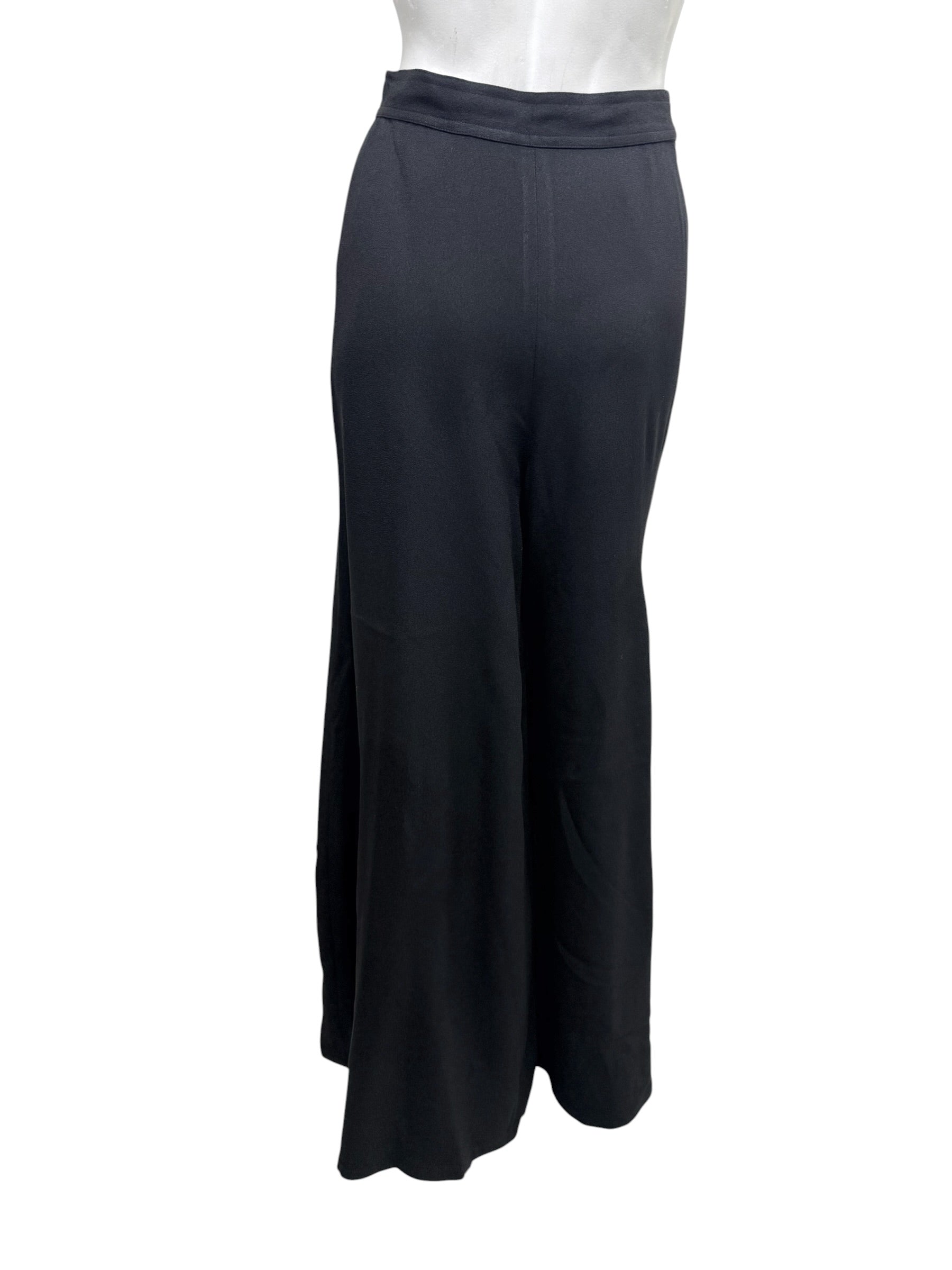 Rear view of vintage Sonia Rykiel Paris black high-waisted wide leg trousers displaying clean tailoring and flowing silhouette.