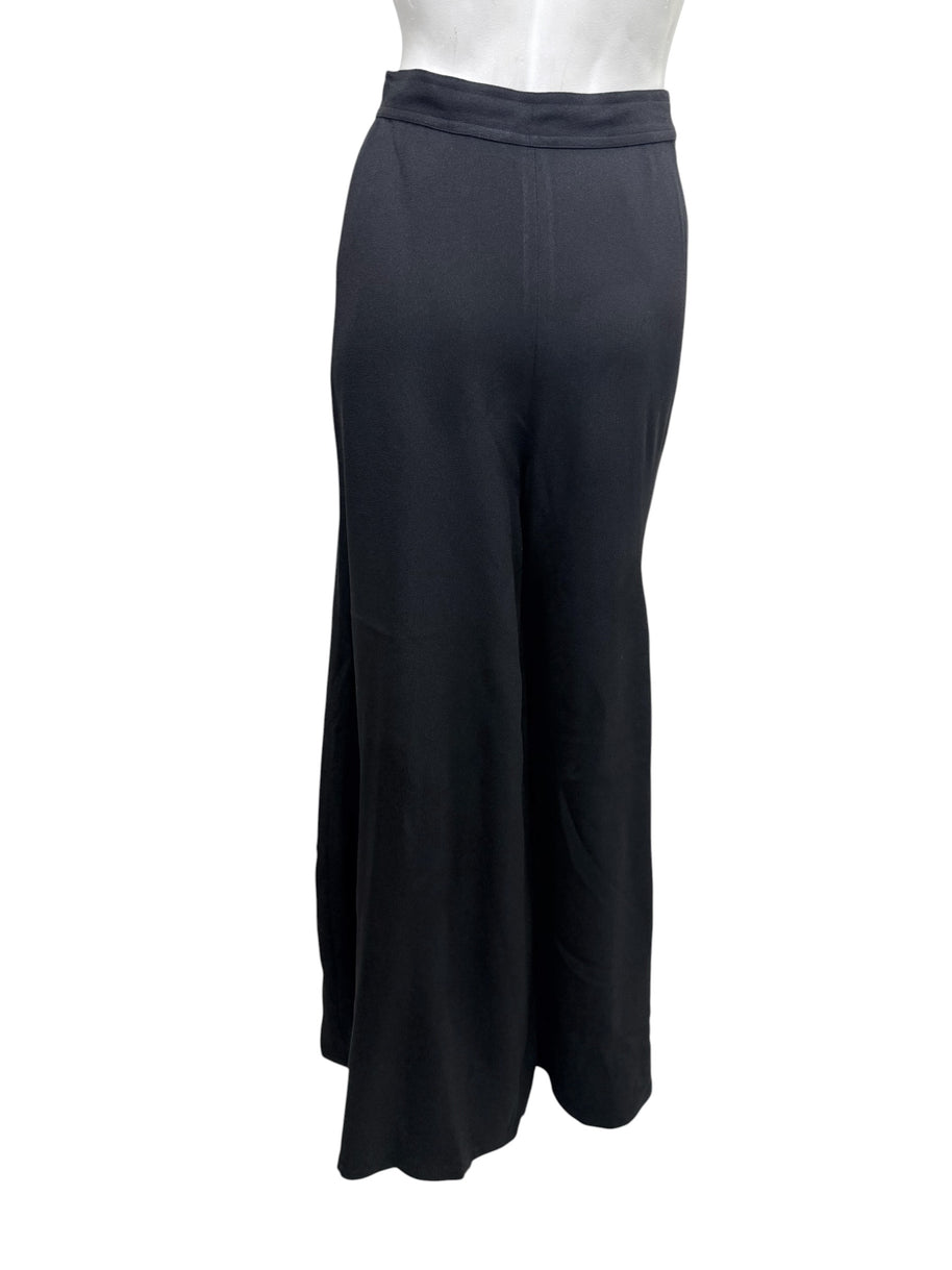 Rear view of vintage Sonia Rykiel Paris black high-waisted wide leg trousers displaying clean tailoring and flowing silhouette.