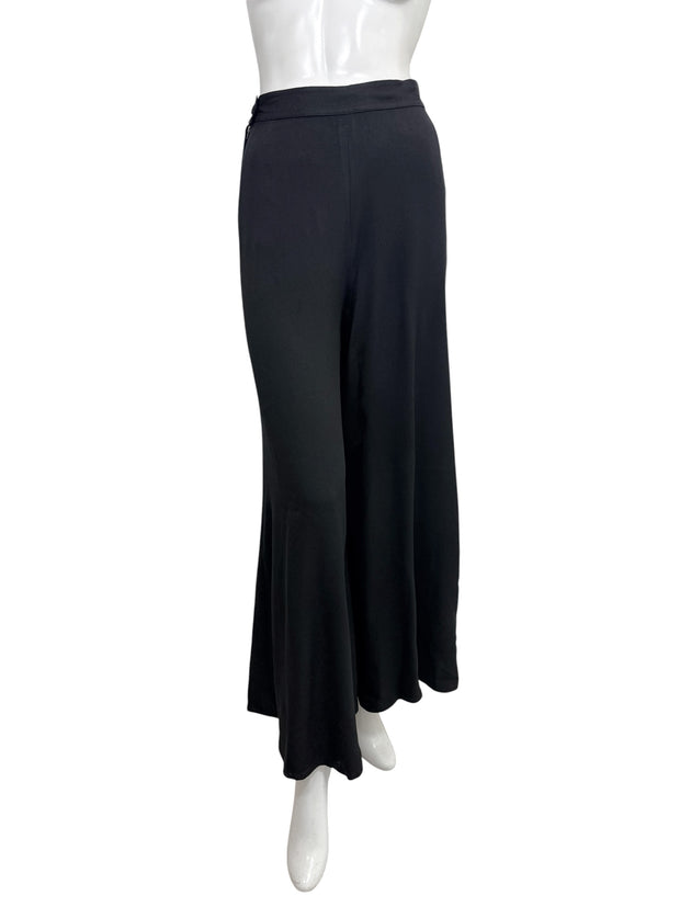 Vintage Sonia Rykiel Paris black high-waisted wide leg trousers photographed from the front on a mannequin, showcasing the fluid drape and minimalist French tailoring.