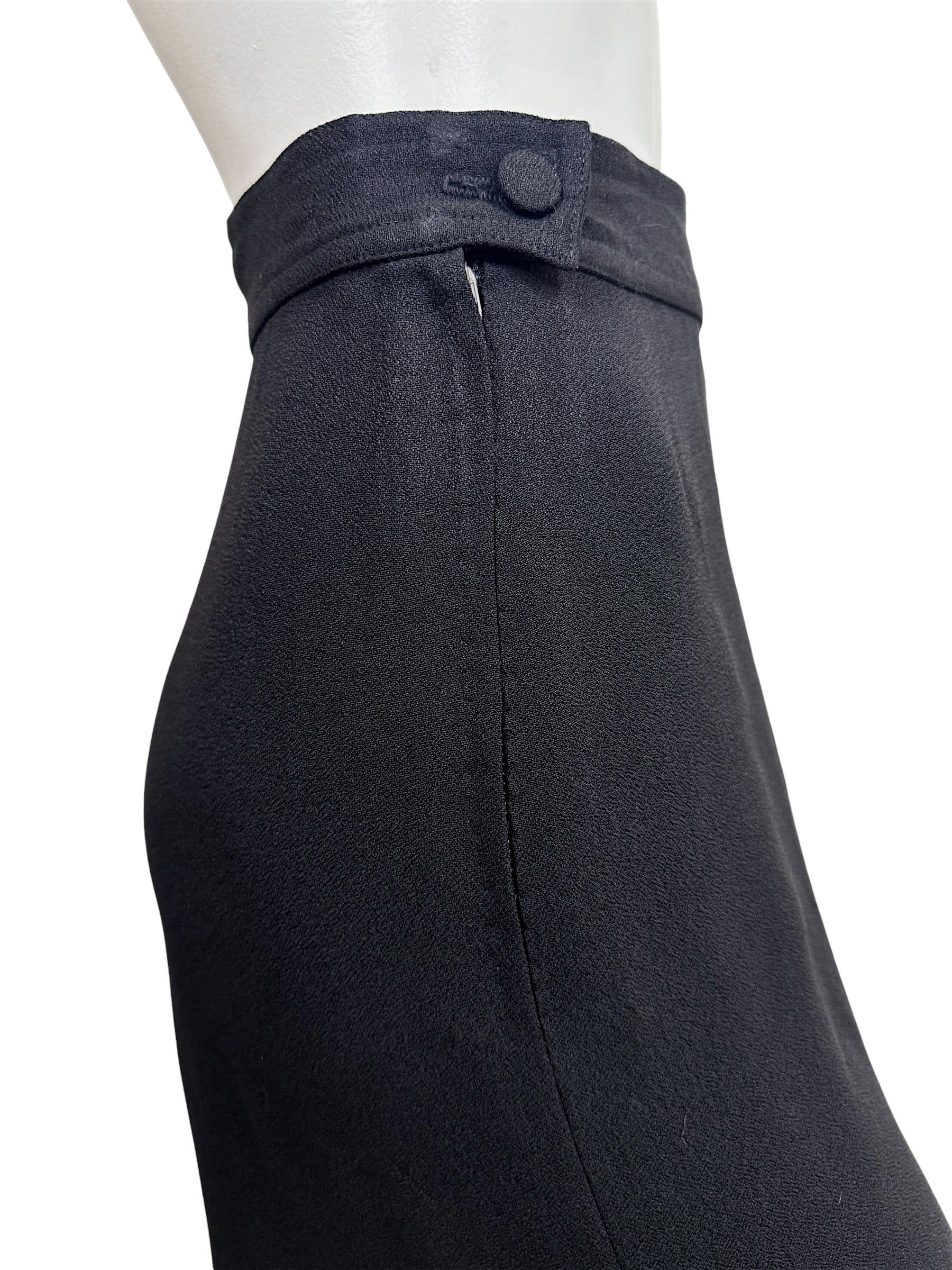 Close-up of the waist button and concealed side zipper closure on vintage Sonia Rykiel Paris black trousers.