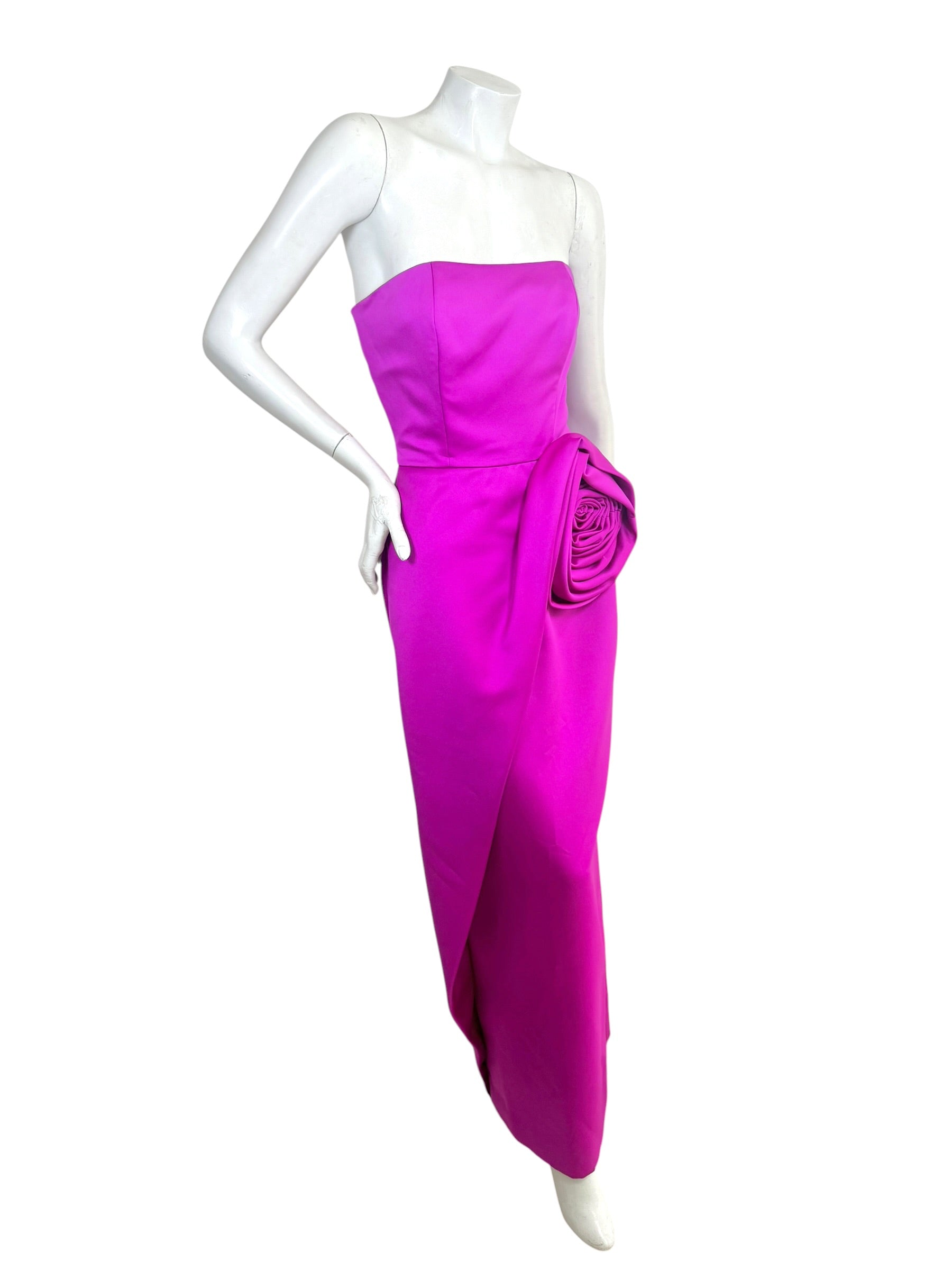 Vintage Victor Costa for Saks Fifth Avenue strapless fuchsia evening gown featuring an oversized sculptural rosette at the hip, elegant column silhouette, and dramatic draped detail shown in a front three-quarter view.